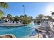 Relaxing lazy river-style pool with comfortable lounge chairs and tropical foliage at 8959 Stinger Dr, Champions Gate, FL 33896