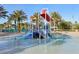 Community pool area with water play equipment surrounded by tropical landscaping at 8959 Stinger Dr, Champions Gate, FL 33896