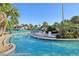 A winding lazy river-style pool lined with comfortable lounge chairs and lush landscaping at 8959 Stinger Dr, Champions Gate, FL 33896