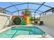 Inviting backyard pool area with a playful retreat theme, screened-in lanai, and serene ambiance at 8959 Stinger Dr, Champions Gate, FL 33896