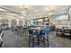 Elegant restaurant with bar, multiple tables, and contemporary lighting fixtures at 8959 Stinger Dr, Champions Gate, FL 33896