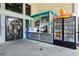 Outdoor sundries kiosk with snacks, drinks, and pool toys near clubhouse entrance at 8959 Stinger Dr, Champions Gate, FL 33896