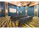 A private movie theater with rows of comfortable seating and a large screen at 8959 Stinger Dr, Champions Gate, FL 33896