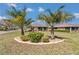 Expansive backyard showcasing lush greenery, mature landscaping with palm trees, and a screened-in lanai at 9491 Sw 98Th Ct, Ocala, FL 34481
