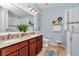 Bright bathroom with double vanity, large mirror, and a walk-in shower at 9491 Sw 98Th Ct, Ocala, FL 34481