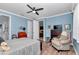 Comfortable bedroom with sitting area, ceiling fan, and neutral decor at 9491 Sw 98Th Ct, Ocala, FL 34481