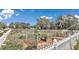 Well-maintained community garden featuring individual plots and diverse vegetation, enclosed by a white picket fence at 9491 Sw 98Th Ct, Ocala, FL 34481