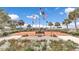The community space has multiple flags waving in the wind, landscaping, and benches at 9491 Sw 98Th Ct, Ocala, FL 34481