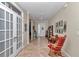 Inviting foyer with tile flooring, French doors, a decorative console, and plenty of natural light at 9491 Sw 98Th Ct, Ocala, FL 34481