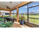 Inviting lanai with patio furniture, a ceiling fan, and a clear view of the lush, green backyard at 9491 Sw 98Th Ct, Ocala, FL 34481