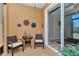 Cozy lanai with seating, decorative wall art, and an open view into the home at 9491 Sw 98Th Ct, Ocala, FL 34481