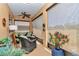 Covered lanai offering a relaxing outdoor living space with comfortable seating and scenic backyard views at 9491 Sw 98Th Ct, Ocala, FL 34481