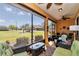 Enjoy this inviting screened-in lanai with outdoor furniture and a serene view of the well-manicured lawn at 9491 Sw 98Th Ct, Ocala, FL 34481