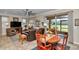 Open-concept living room with tile flooring, modern fan, and sliding glass doors to a screened-in porch at 9491 Sw 98Th Ct, Ocala, FL 34481