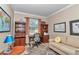 Inviting home office features a desk, comfortable sofa, bookcase, and large windows at 9491 Sw 98Th Ct, Ocala, FL 34481