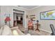 Stylish home office offers a desk, rocking chair, sofa, and a view of the kitchen at 9491 Sw 98Th Ct, Ocala, FL 34481