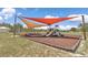 Community playground with slides, swings, and benches, covered by shade structures at 9491 Sw 98Th Ct, Ocala, FL 34481