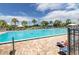 Large community swimming pool with lounge chairs and umbrellas, perfect for relaxation and recreation at 9491 Sw 98Th Ct, Ocala, FL 34481