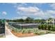 Well-maintained tennis courts offer a great recreational amenity surrounded by lush greenery and a clear blue sky at 9491 Sw 98Th Ct, Ocala, FL 34481