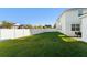 Spacious backyard with lush green grass and a white vinyl fence at 9844 Pecan Hickory Way, Orlando, FL 32832