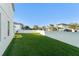 Expansive backyard featuring green grass and a white vinyl fence at 9844 Pecan Hickory Way, Orlando, FL 32832