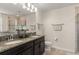 Bathroom featuring double sinks, granite countertops, and tiled glass shower enclosure at 9844 Pecan Hickory Way, Orlando, FL 32832