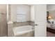 Beautiful bathroom with a tiled shower and luxurious white bathtub at 9844 Pecan Hickory Way, Orlando, FL 32832