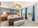 Bedroom featuring blue curtains, soft lighting, and a comfortable queen-size bed at 9844 Pecan Hickory Way, Orlando, FL 32832