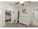 Sweet Bedroom featuring a crib and decorative growth chart for the growing Gathering at 9844 Pecan Hickory Way, Orlando, FL 32832