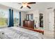Sunlit bedroom features large windows, a ceiling fan, and closet perfect for storage at 9844 Pecan Hickory Way, Orlando, FL 32832