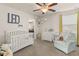 Comfortable Bedroom with natural light, seating, crib and delightful decor at 9844 Pecan Hickory Way, Orlando, FL 32832