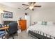Bedroom featuring neutral walls, a work space, queen bed, and overhead fan at 9844 Pecan Hickory Way, Orlando, FL 32832