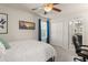 Well-lit bedroom featuring ceiling fan, closet, picture window and adjoining bath at 9844 Pecan Hickory Way, Orlando, FL 32832