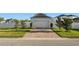 Paver driveway leading to a two-car garage at 9844 Pecan Hickory Way, Orlando, FL 32832