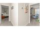 Neutral hallway featuring two bedroom entrances and decoratively adorned with artwork at 9844 Pecan Hickory Way, Orlando, FL 32832