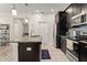 Well-equipped kitchen with stainless steel appliances, granite countertops, a breakfast bar, and dark cabinets at 9844 Pecan Hickory Way, Orlando, FL 32832