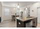 Bright eat-in kitchen area with granite countertops, dark cabinetry, stainless steel appliances, and table at 9844 Pecan Hickory Way, Orlando, FL 32832