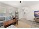 Bright living room features a sectional sofa, modern flooring, and a shelving unit at 9844 Pecan Hickory Way, Orlando, FL 32832