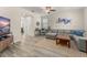 Cozy living room features modern flooring, a sectional sofa, and abundant natural light at 9844 Pecan Hickory Way, Orlando, FL 32832