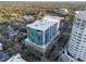 Aerial view of a modern condominium in a vibrant city setting with lush greenery at 101 S Eola Dr # 910, Orlando, FL 32801