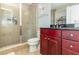 Bathroom featuring a shower with a glass enclosure, toilet, vanity and dark wood cabinets at 101 S Eola Dr # 910, Orlando, FL 32801