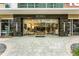 Contemporary building entrance with glass doors and gray stone accents at 101 S Eola Dr # 910, Orlando, FL 32801