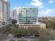 Modern high-rise condominium featuring sleek glass windows and an inviting pool deck at 101 S Eola Dr # 910, Orlando, FL 32801