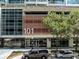 Modern condo building exterior showing entrance, landscaping, and parking for the 101 Eola complex at 101 S Eola Dr # 910, Orlando, FL 32801