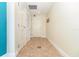 Neutral hallway with tiled flooring and multiple white doors at 101 S Eola Dr # 910, Orlando, FL 32801