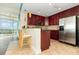 Well-lit kitchen area with breakfast bar and cherry cabinets at 101 S Eola Dr # 910, Orlando, FL 32801