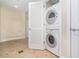 Laundry room featuring tile flooring and a stacked washer and dryer at 101 S Eola Dr # 910, Orlando, FL 32801