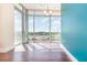 Bright living room featuring large windows offering beautiful city views and hardwood floors at 101 S Eola Dr # 910, Orlando, FL 32801