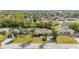 Neighborhood shot of well-kept homes with mature trees; lake in the distance at 1061 Radford Dr, Deltona, FL 32738