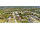 Expansive aerial view of the neighborhood showcasing the home's location near a lake and lush greenery at 1061 Radford Dr, Deltona, FL 32738